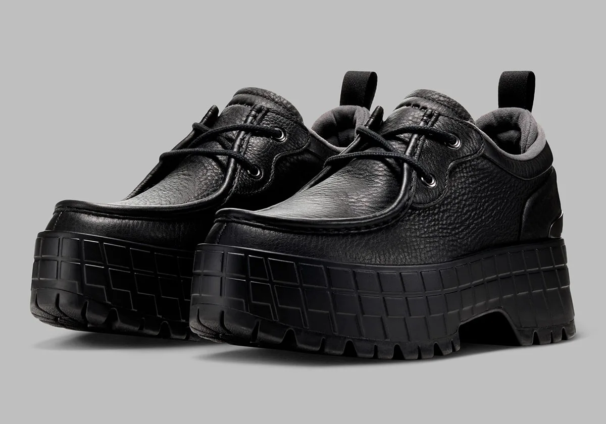 three-quarter pair view, black leather uppers on chunky black lugged soles, Jordan 1 Brooklyn