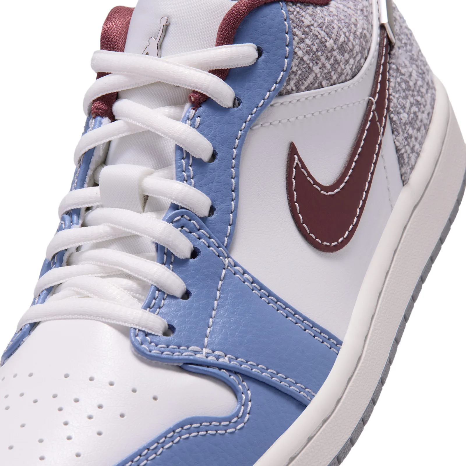 Close-up toe detail, maroon swoosh, blue overlay, white perforated toe box, Bouclé