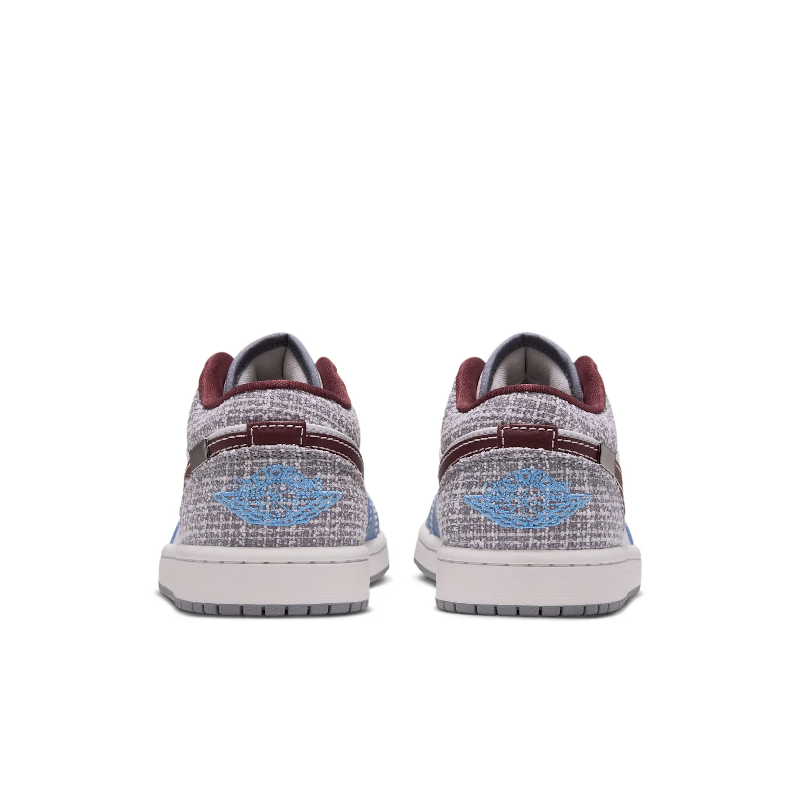 Heel view of pair, blue embroidered Wings logo on grey bouclé texture, Bouclé