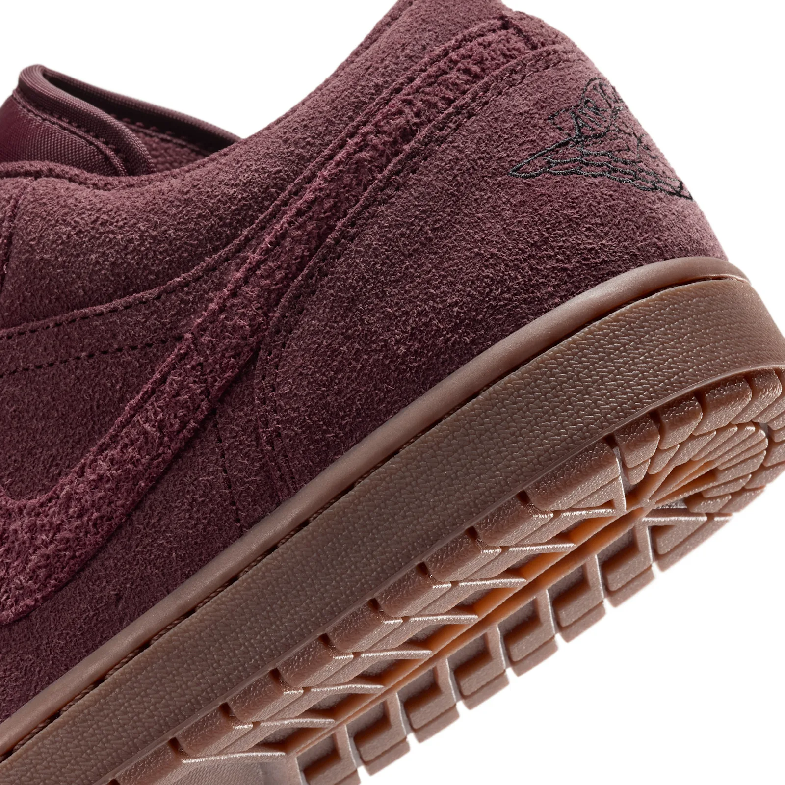 close-up of heel and outsole showing textured burgundy suede and Wings logo, Dark Team Red