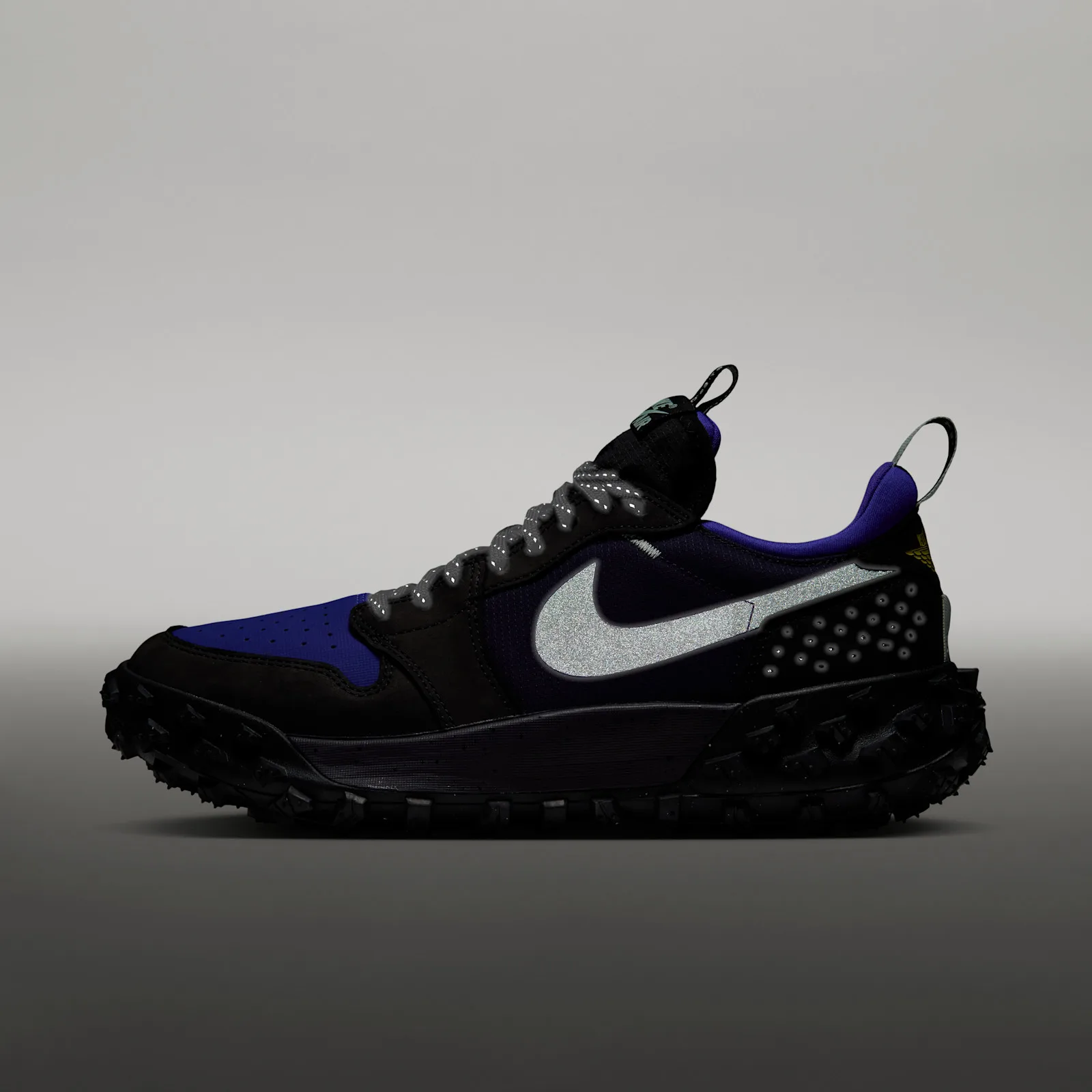 lateral view, reflective silver swoosh glowing under flash, grey gradient backdrop, Low Element GTX