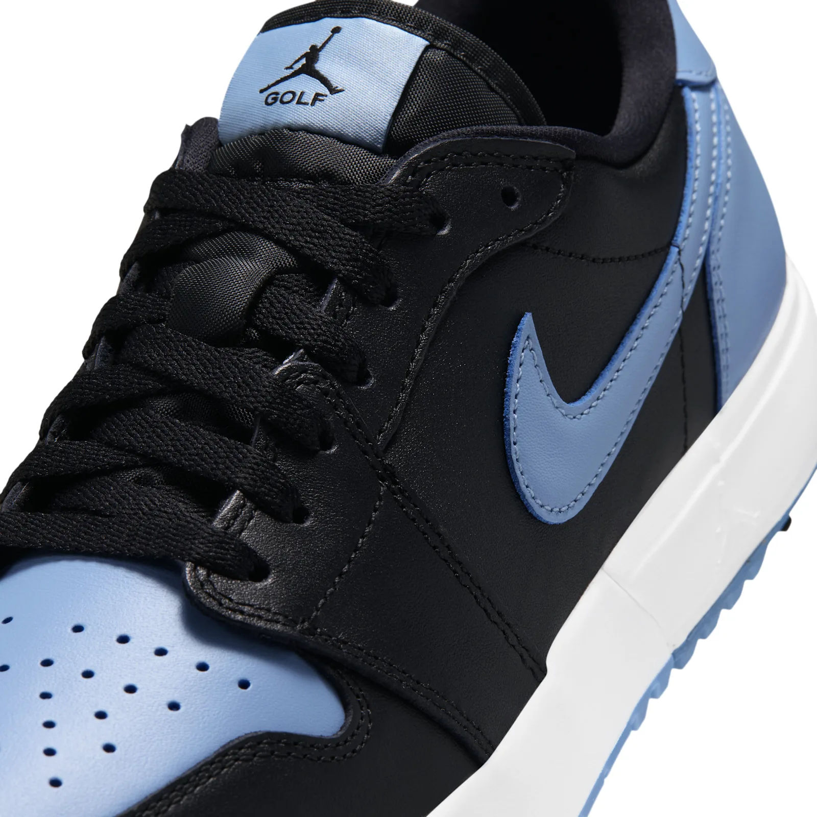 close-up toe and tongue detail, blue Nike swoosh and Jordan Golf tongue tag, Chambray
