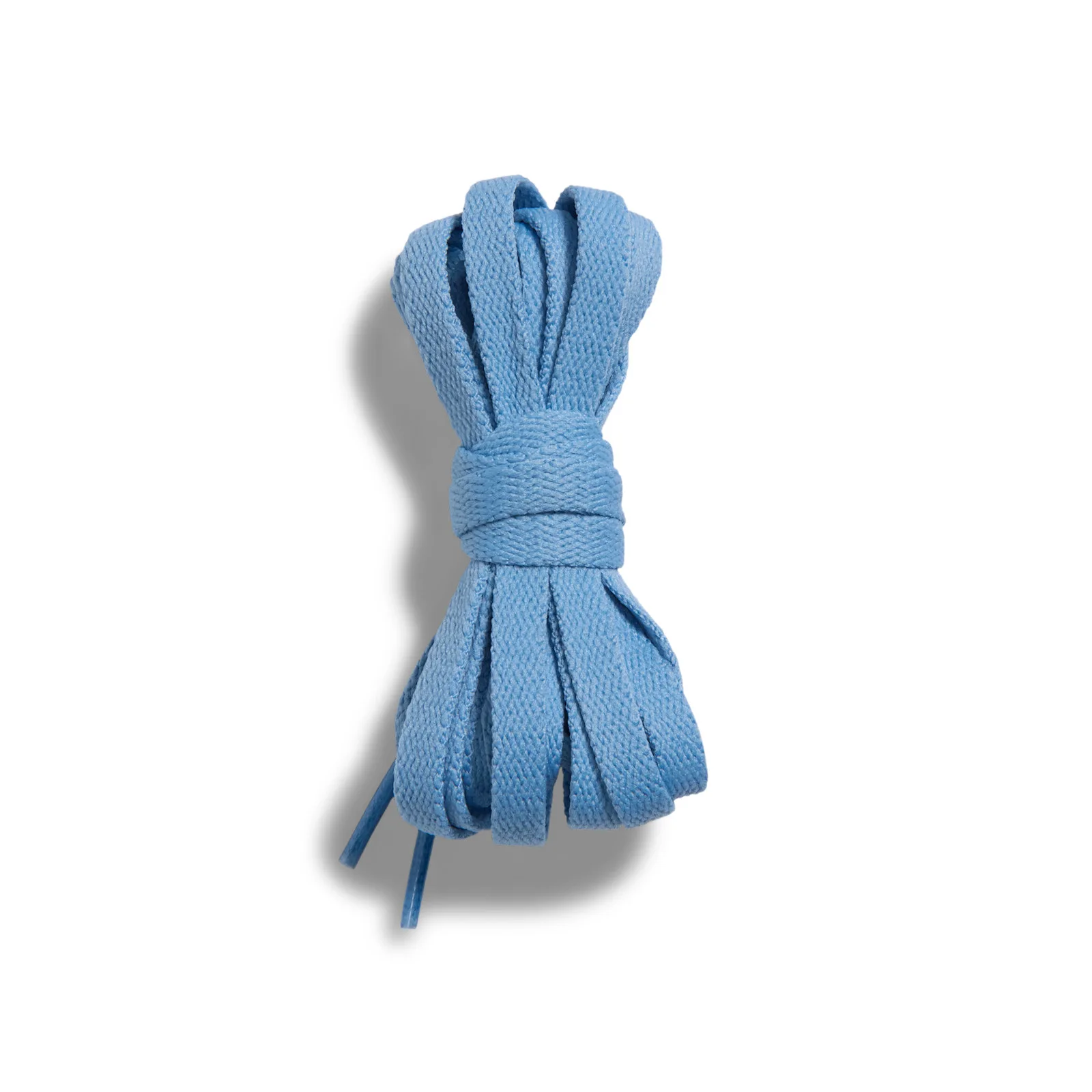 detail of bundled blue flat laces against white background, Chambray