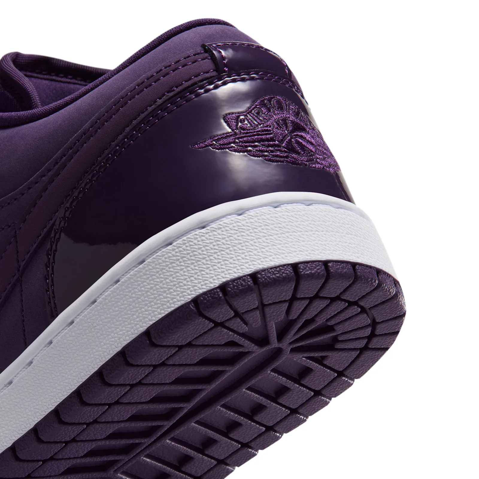 close-up heel detail, glossy purple patent counter with Wings logo, white midsole, Grand Purple