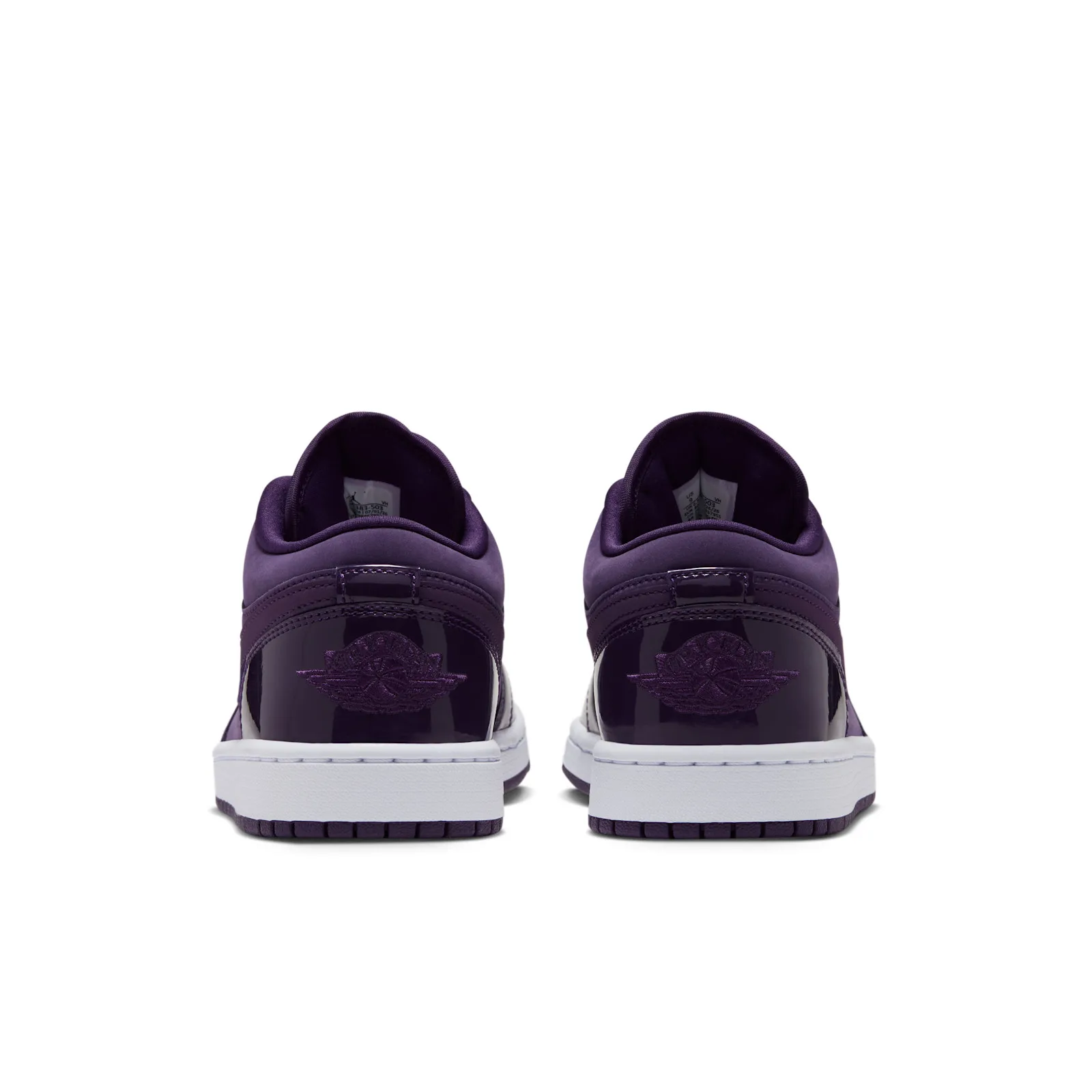 heel view of both shoes, patent purple counters with embroidered Wings logo, Grand Purple