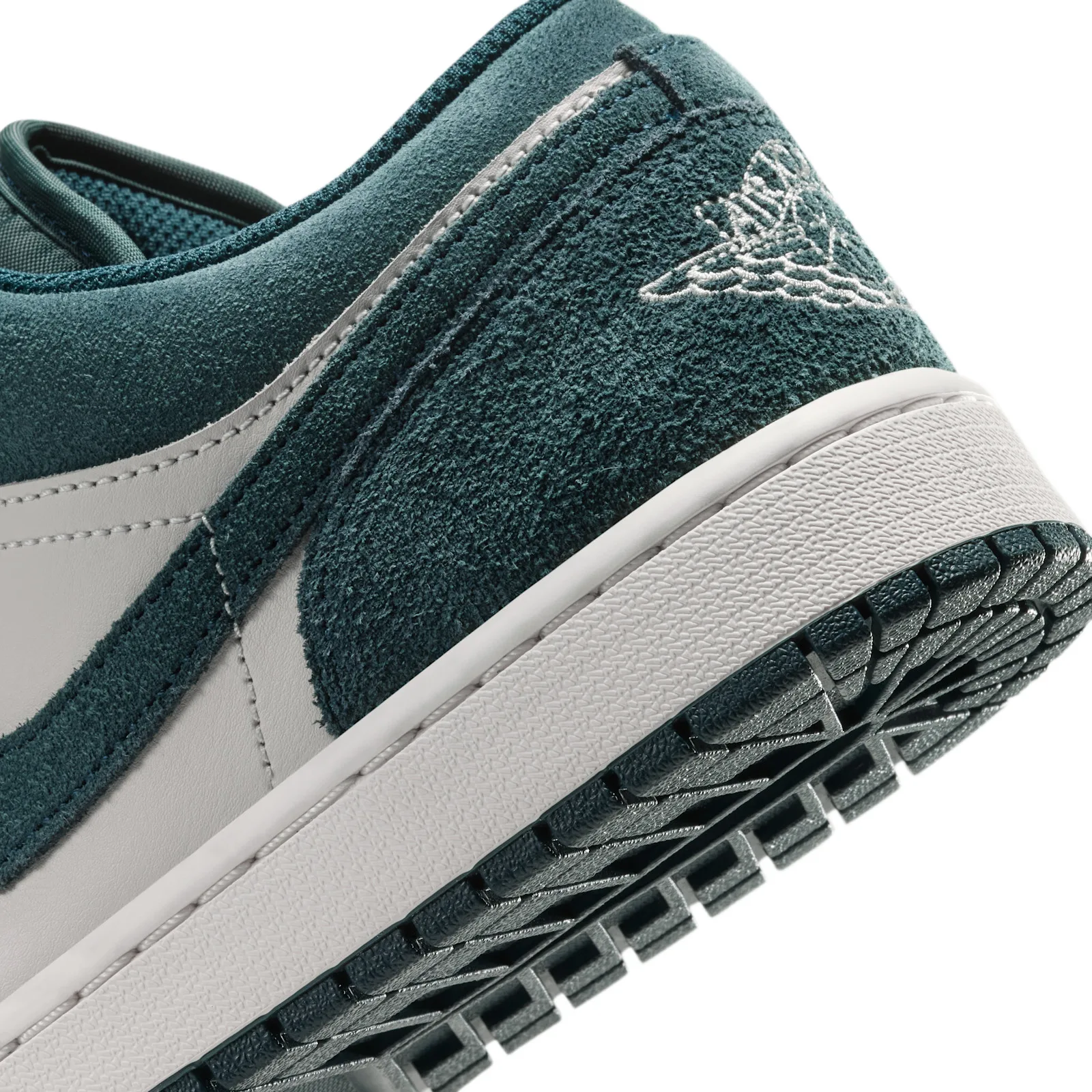 macro detail of teal suede heel with stitched wings logo and white sole, Midnight Spruce