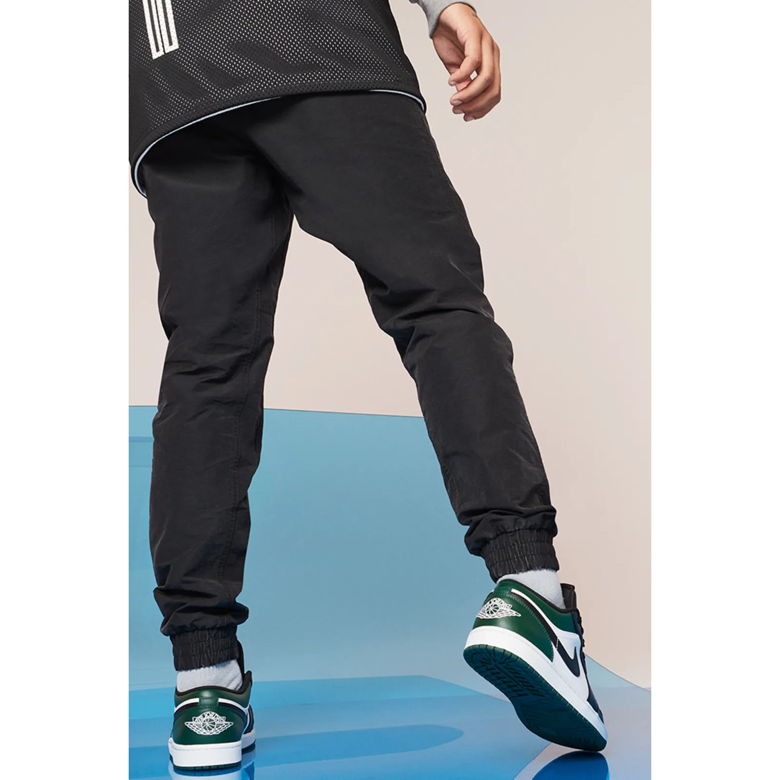 on-foot back view, green, black and white low-top sneakers on model's feet, Midnight Spruce