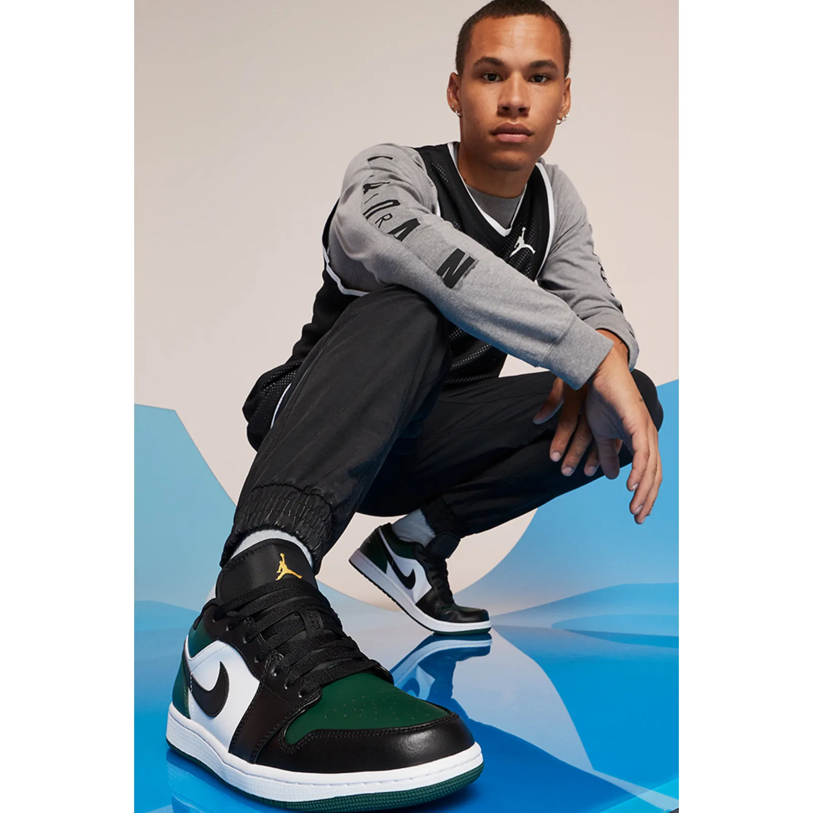 on-foot, model crouching in green, black and white low-top sneakers, Midnight Spruce