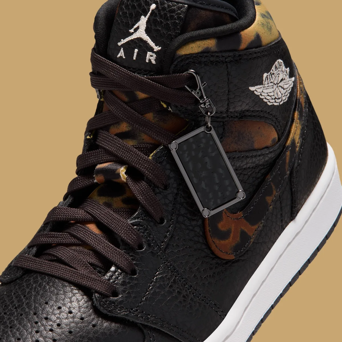 close-up of lace area with black hangtag charm on branded zip pull, Velvet Brown Leopard