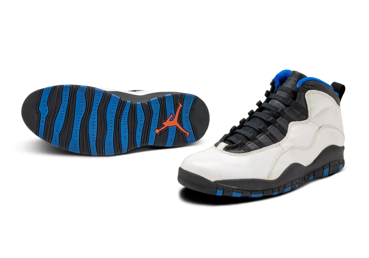 angled pair with outsole raised, blue and black striped sole, orange Jumpman, Knicks