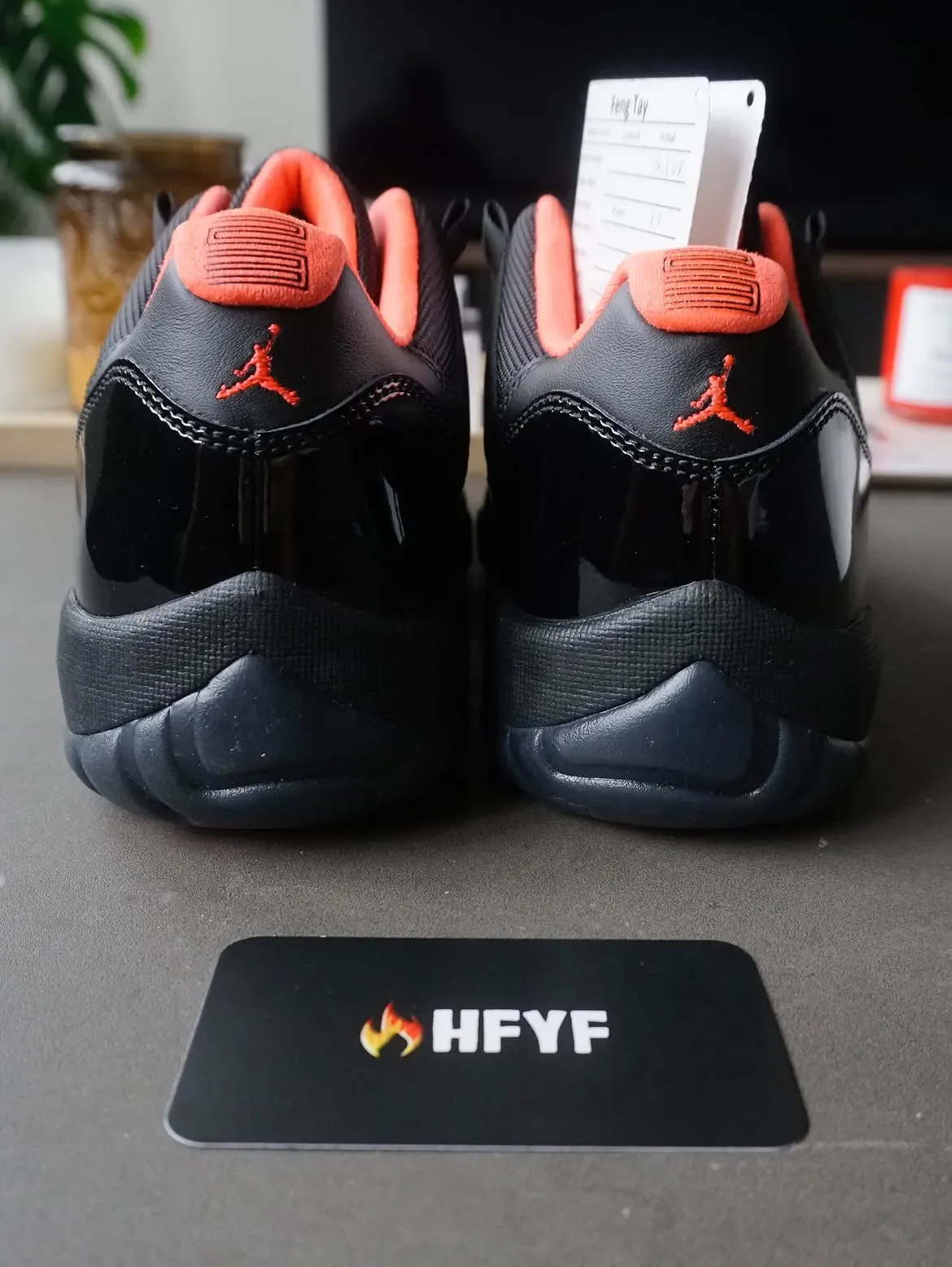 pair heel-on view, black patent counters with coral collar and red Jumpman logo, Black Infrared