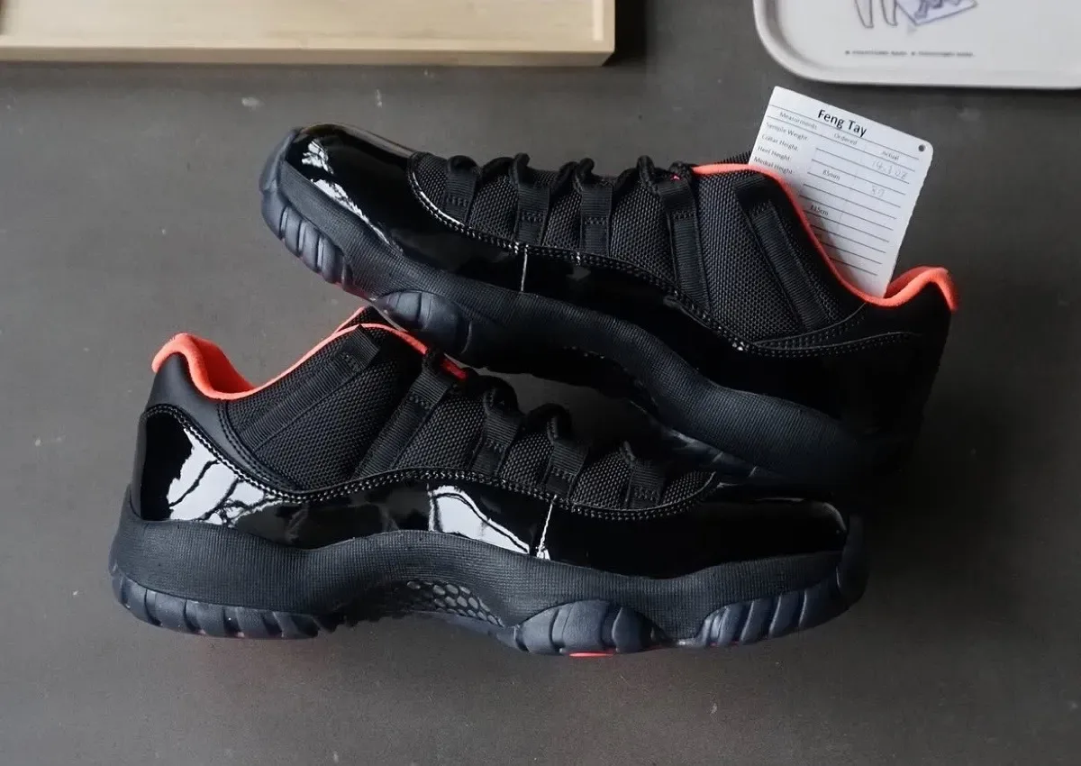 pair shown lateral, glossy black patent toe and heel with coral collar lining, Air Jordan 11 Low "Black Infrared" (Sample)
