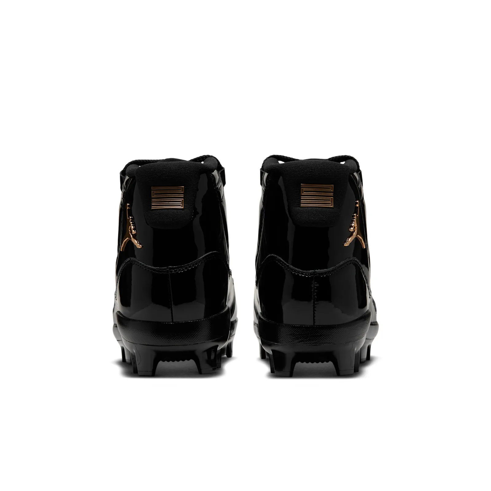 heel view of the pair showing gold jumpman logos and black tongue tabs, MCS Baseball Cleat