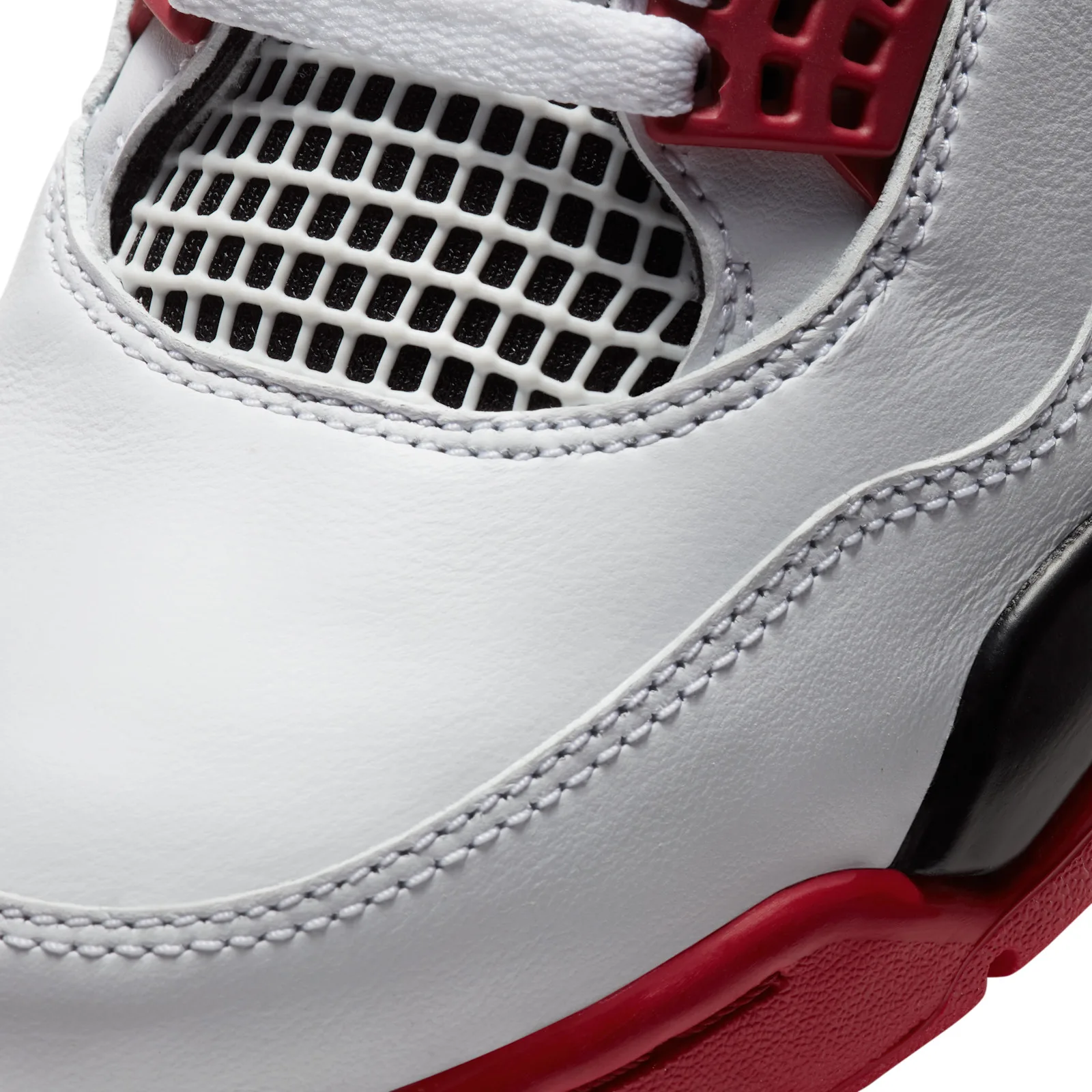 close-up of toe mesh panel and white leather stitching, red midsole edge, Fire Red
