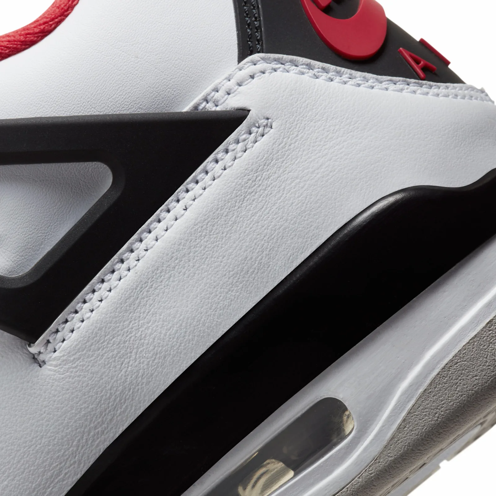 close-up of black plastic wing strut with red 'AIR' lettering, mesh panel, Fire Red
