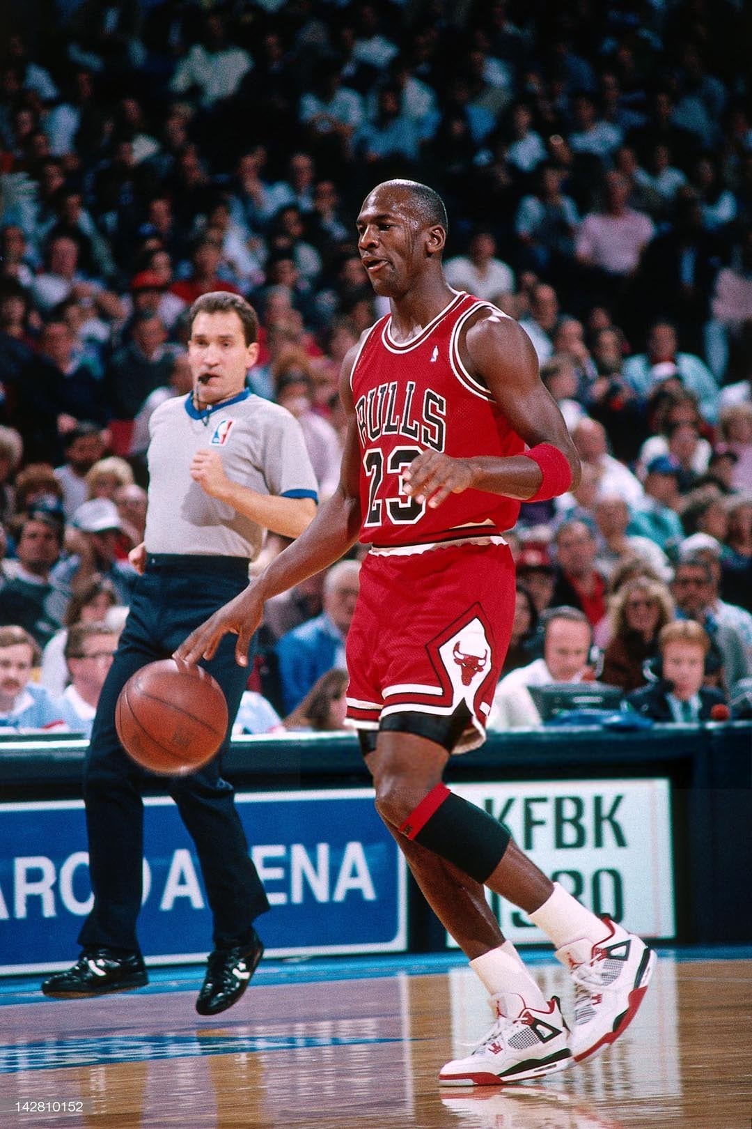 on-foot action, Jordan dribbling in Bulls jersey with white-red sneakers visible, Fire Red