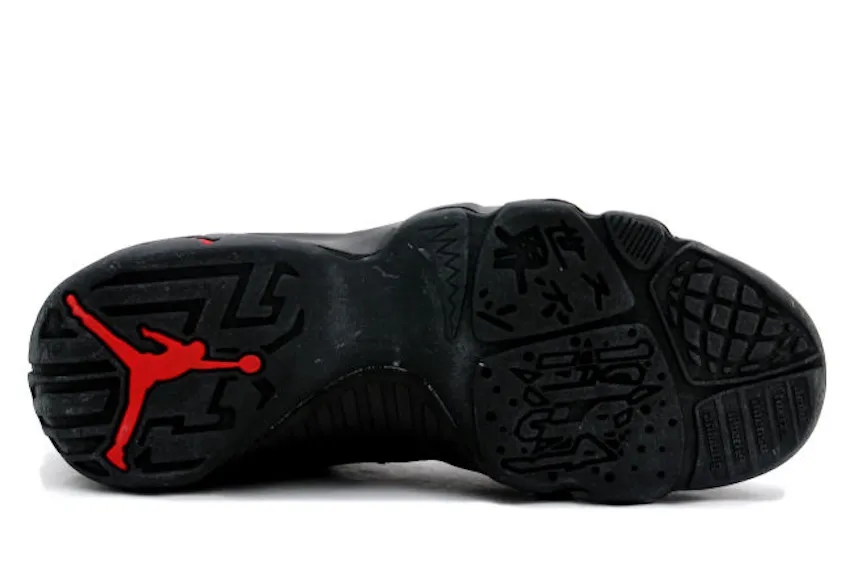 outsole close-up, black tread with red Jumpman logo, Charcoal