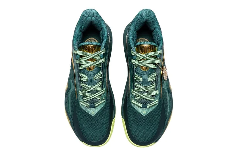 top-down pair view, green woven laces threaded through gold eyelets, Alchemist