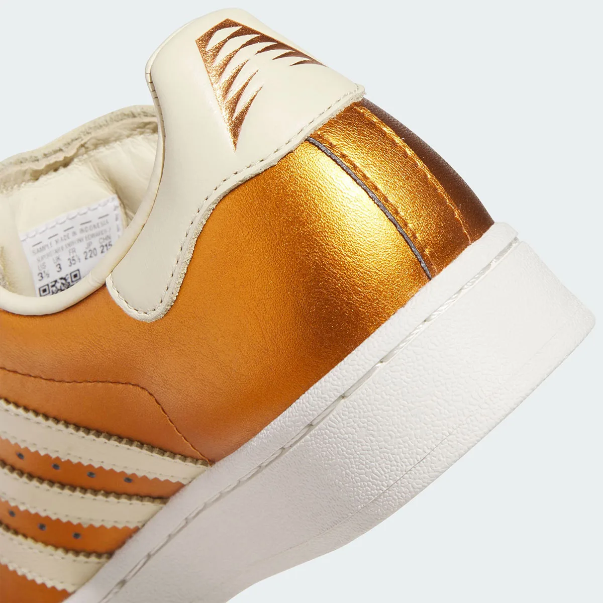 close up heel detail with cream pull tab, size tag and metallic gold leather, Metallic Gold