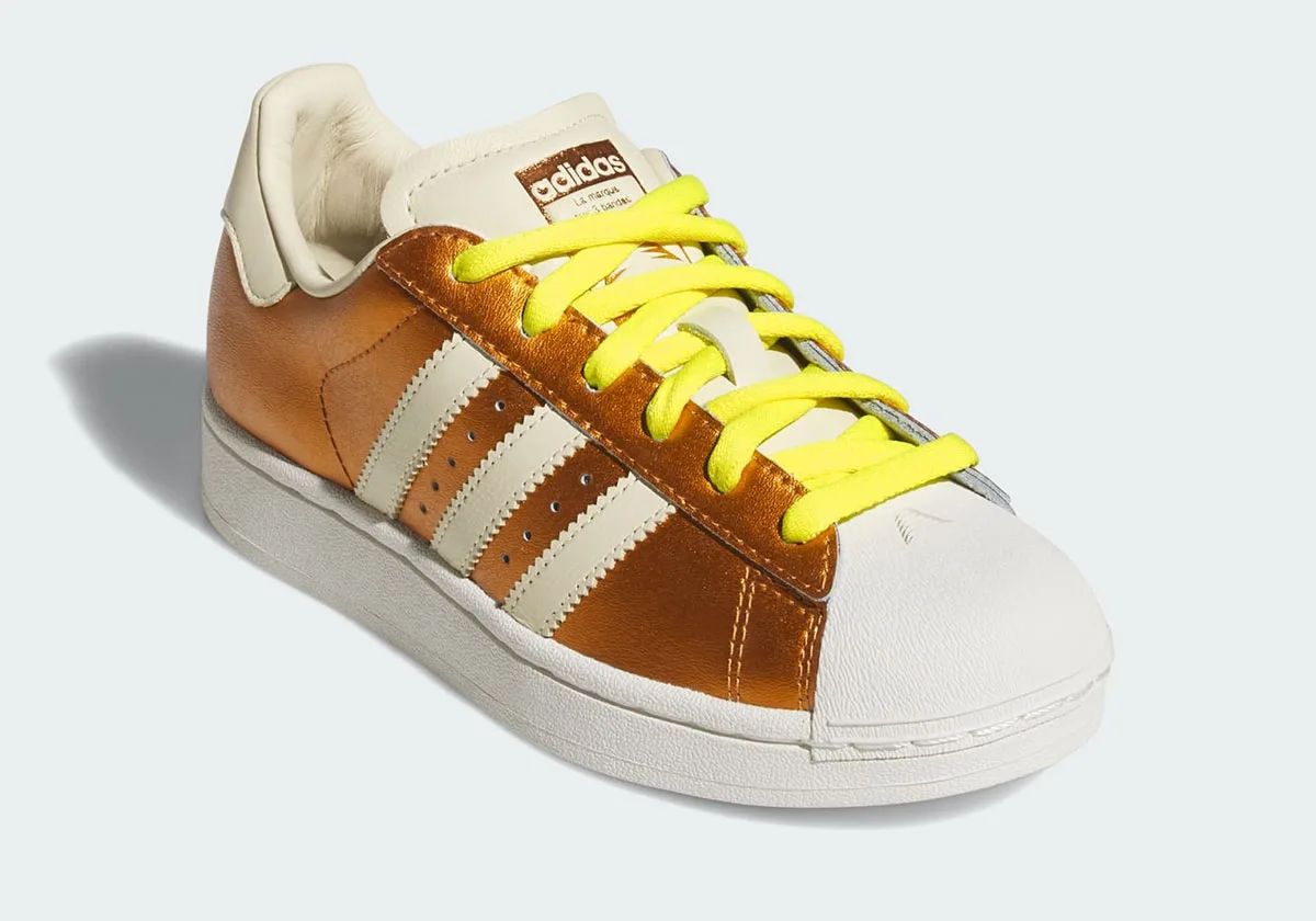 toe and lace angle view, adidas branded tongue tag with yellow laces, Metallic Gold