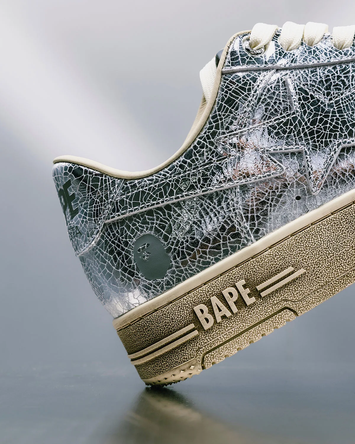 Toe detail, crackled silver-green leather with star and tan crackled outsole, Future
