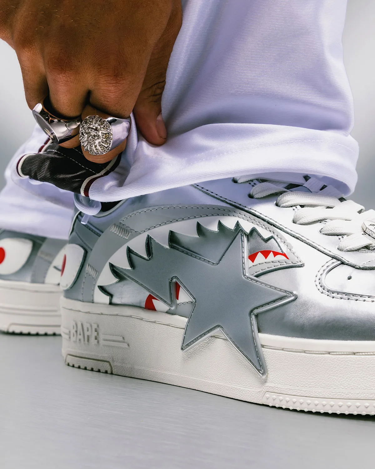 On-foot toe detail, silver shark-mouth toe with red eyes, star, rings on hand, Future