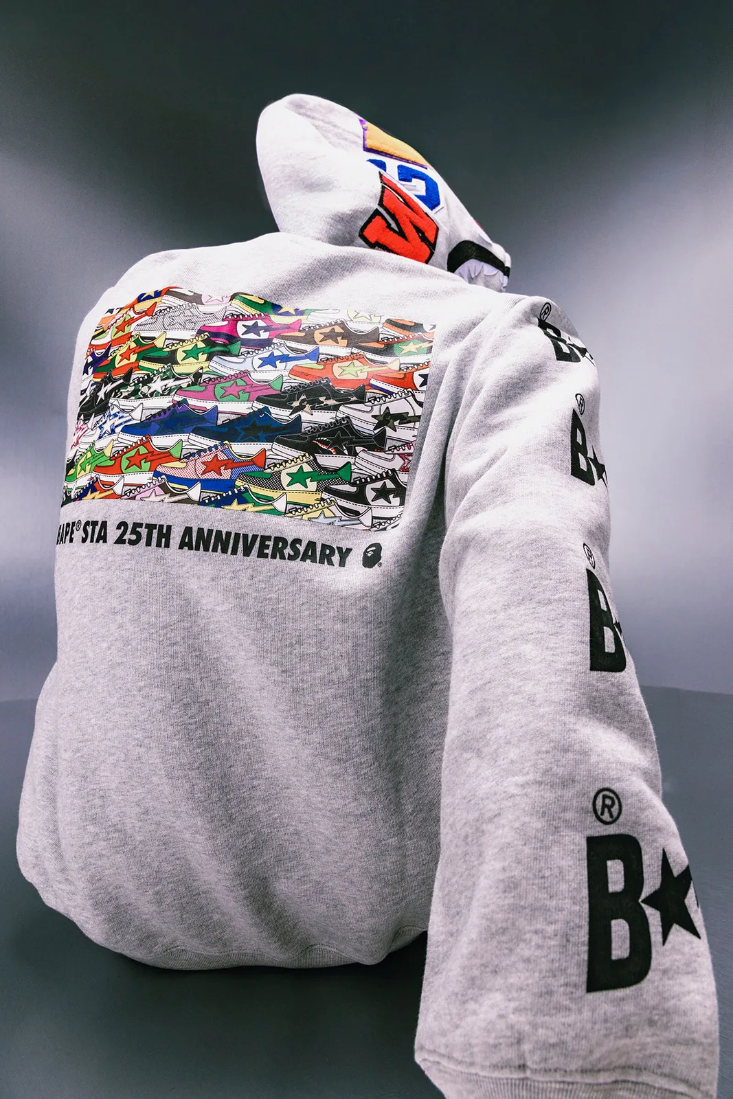 Back view, grey hoodie with sneaker collage print and BAPE STA 25TH ANNIVERSARY text, Future