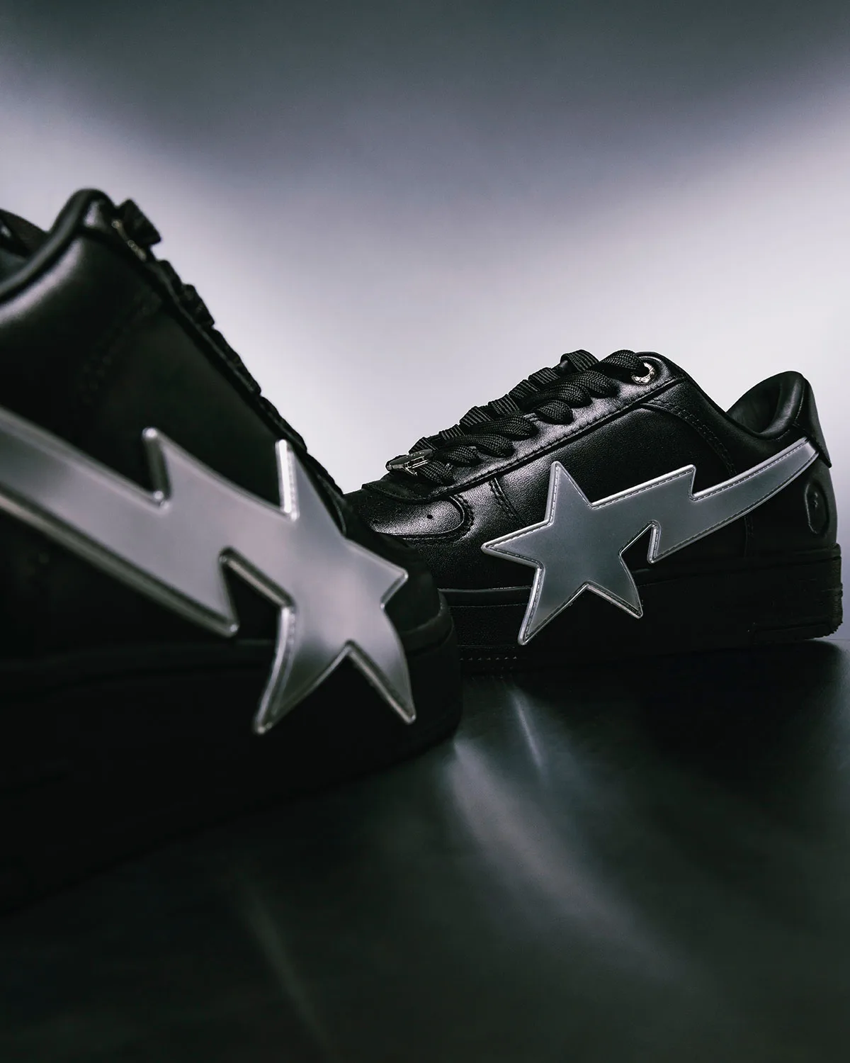 Low-angle heel view, black pair with reflective silver star-lightning appliqué, Future