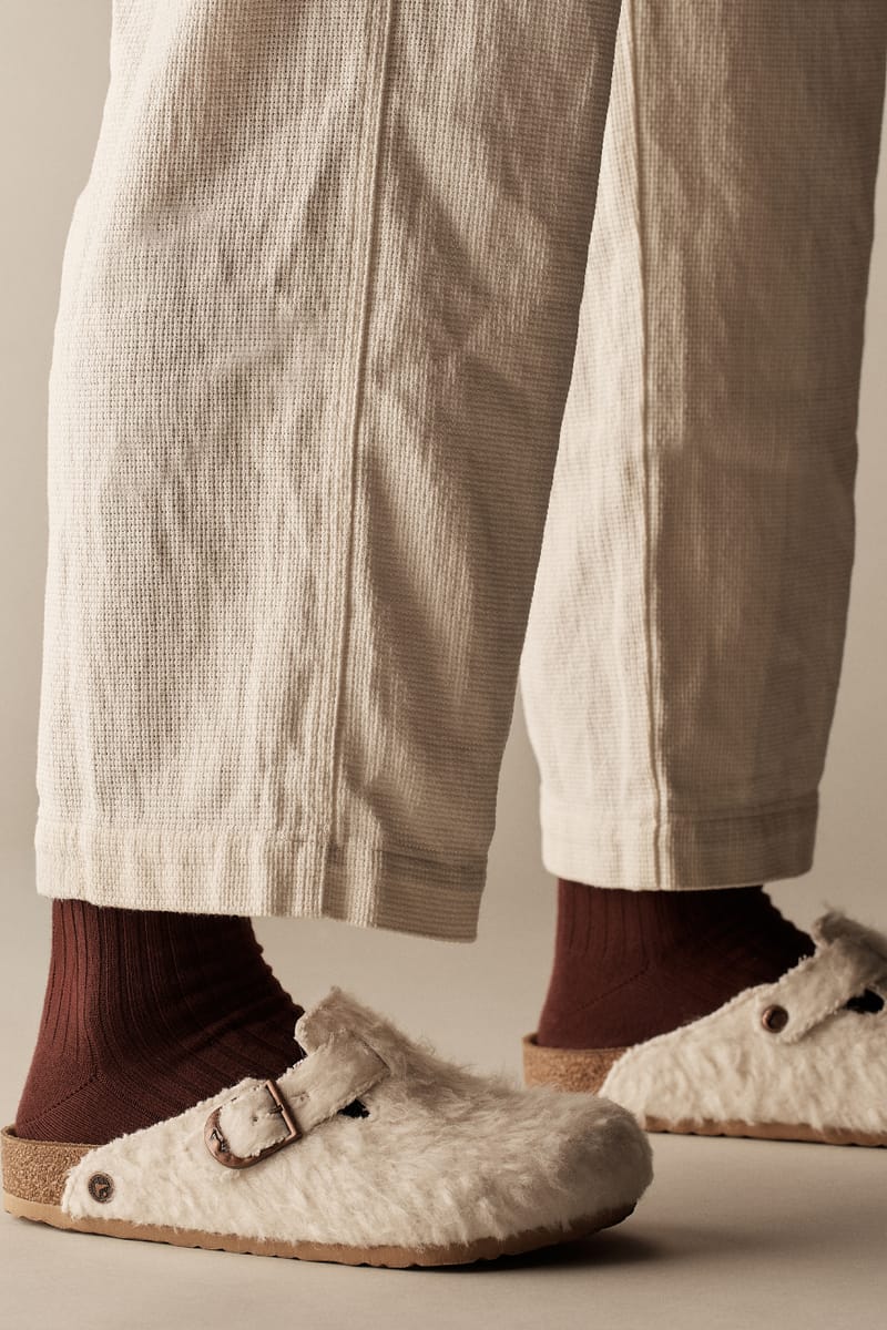 on-foot detail, cream shearling clogs worn with burgundy socks and cream trousers, Wooly Moon Buckle