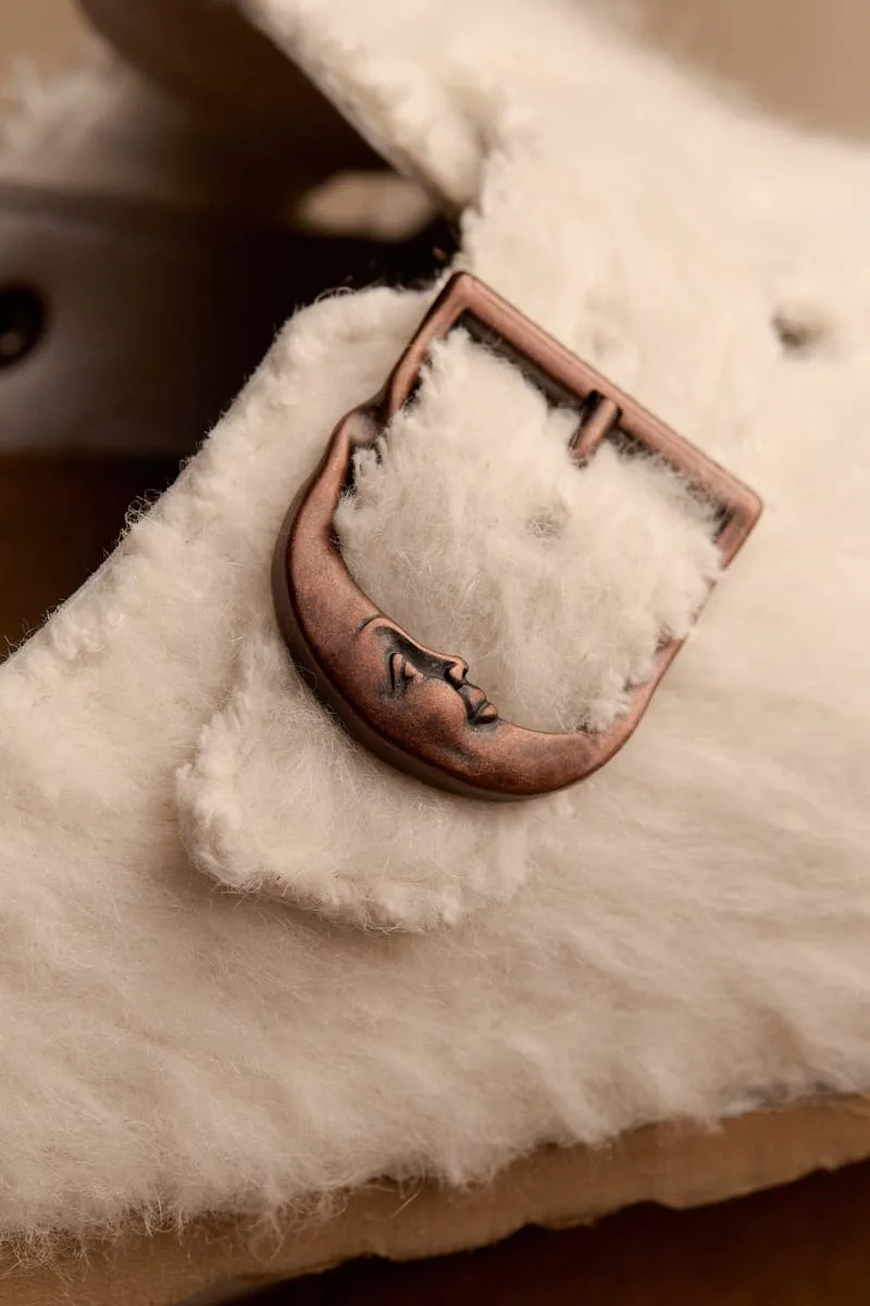 macro detail, copper buckle with engraved crescent moon face on cream shearling, Wooly Moon Buckle