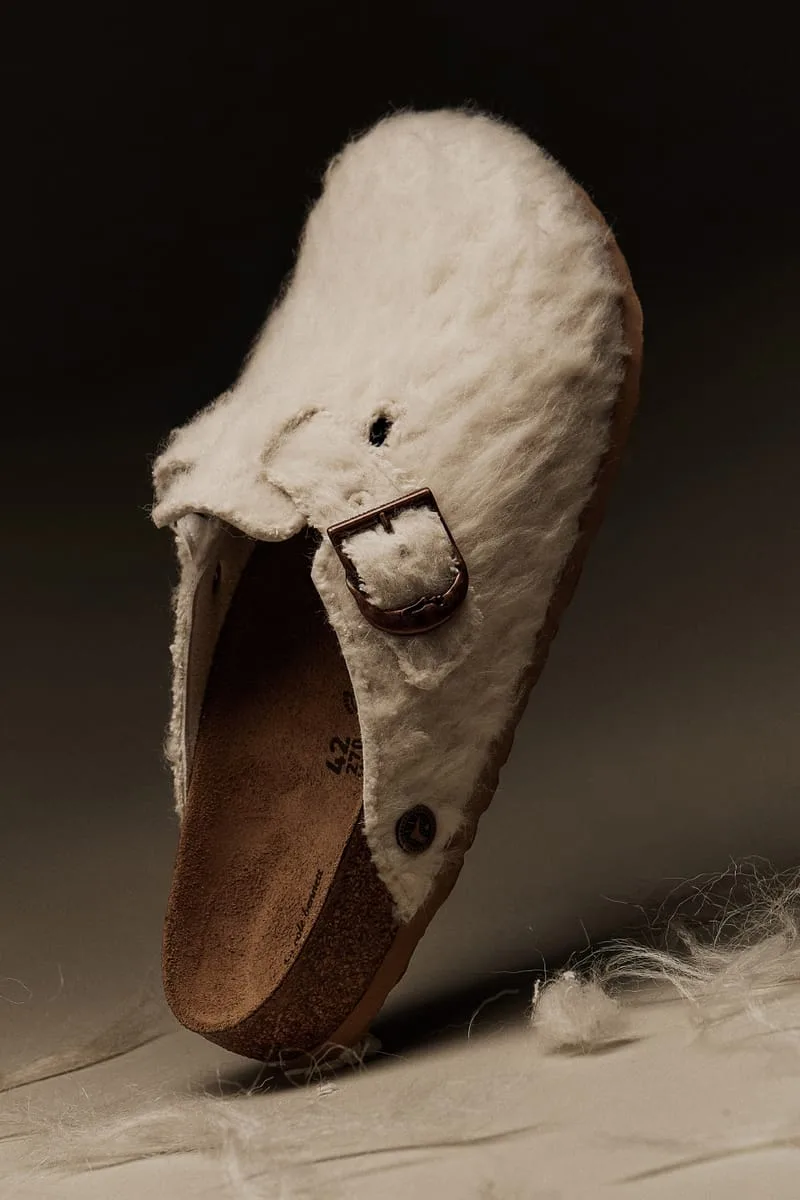 medial view tilted upright, cream shearling exterior showing tan suede footbed, Wooly Moon Buckle