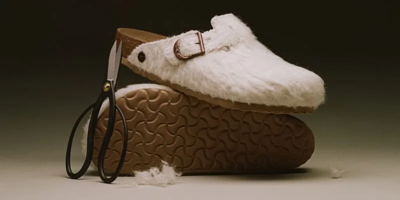 lateral view stacked on outsole, cream shearling clog with scissors and loose fluff, Wooly Moon Buckle