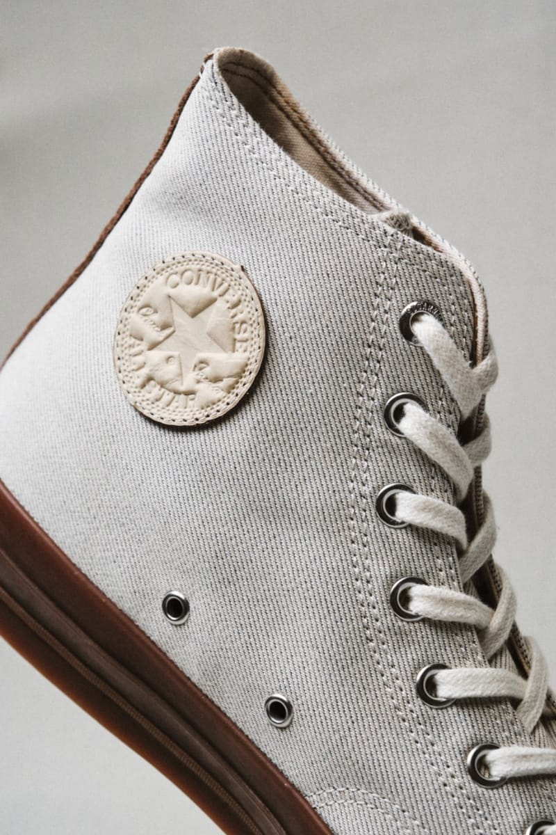 heel detail, tonal embossed Converse patch on cream canvas above brown sole, Natural