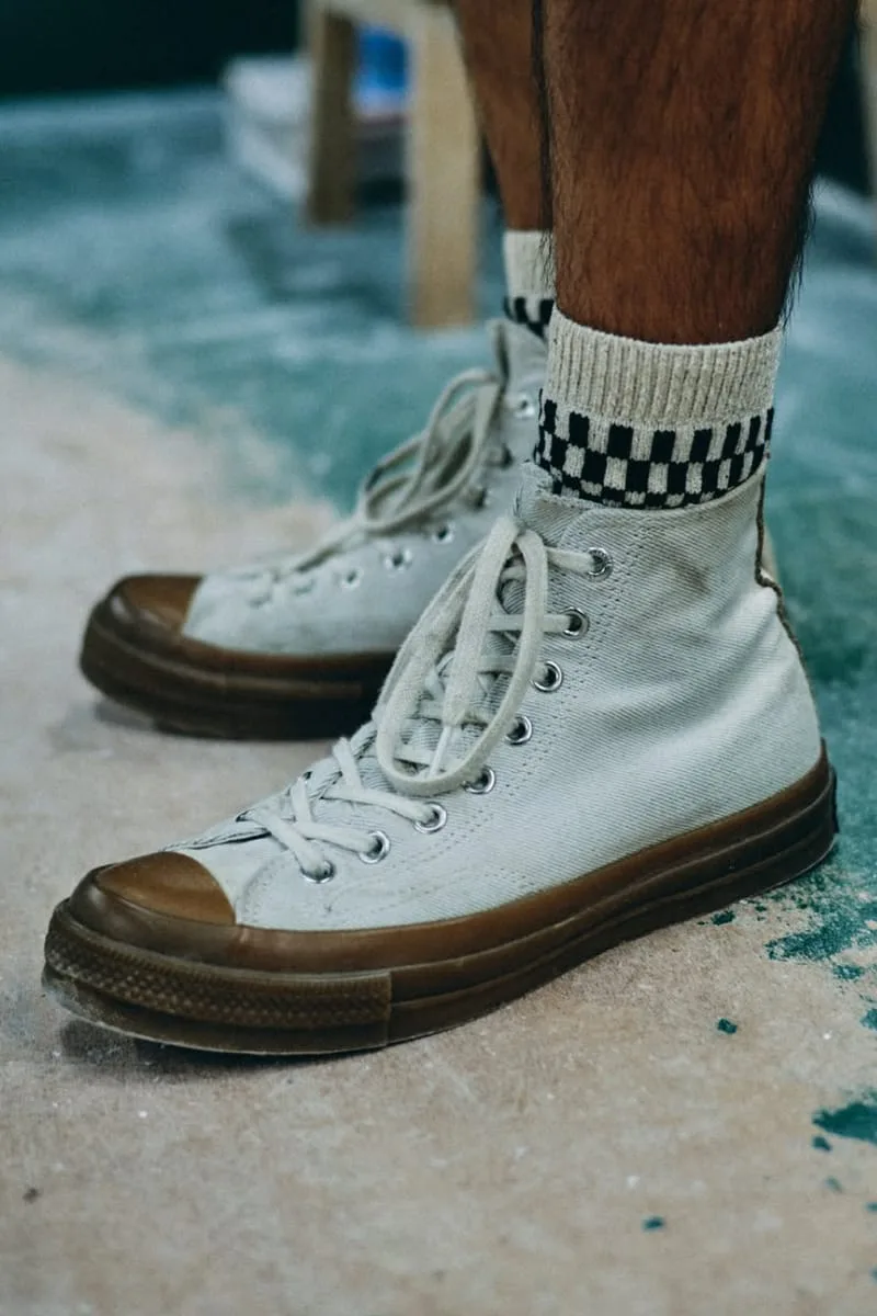 on-foot view, cream high-top with brown sole above checkerboard-cuffed socks, Natural