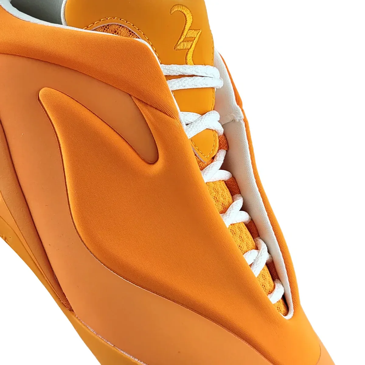 close-up of toe box and lace area, orange textile with white laces and embroidered numeral, Creamsicle