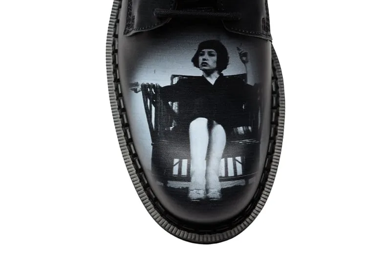 toe close-up, black leather with black-and-white print of a seated woman in a chair, 4 Eyelet Derby