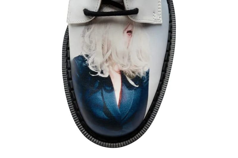 toe close-up, white leather with blue-toned print of a figure with pale hair, 4 Eyelet Derby