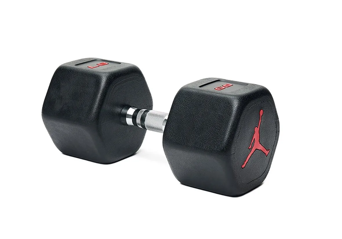 lateral view of black hex dumbbells lying down with chrome grip, Jordan Strength Collection