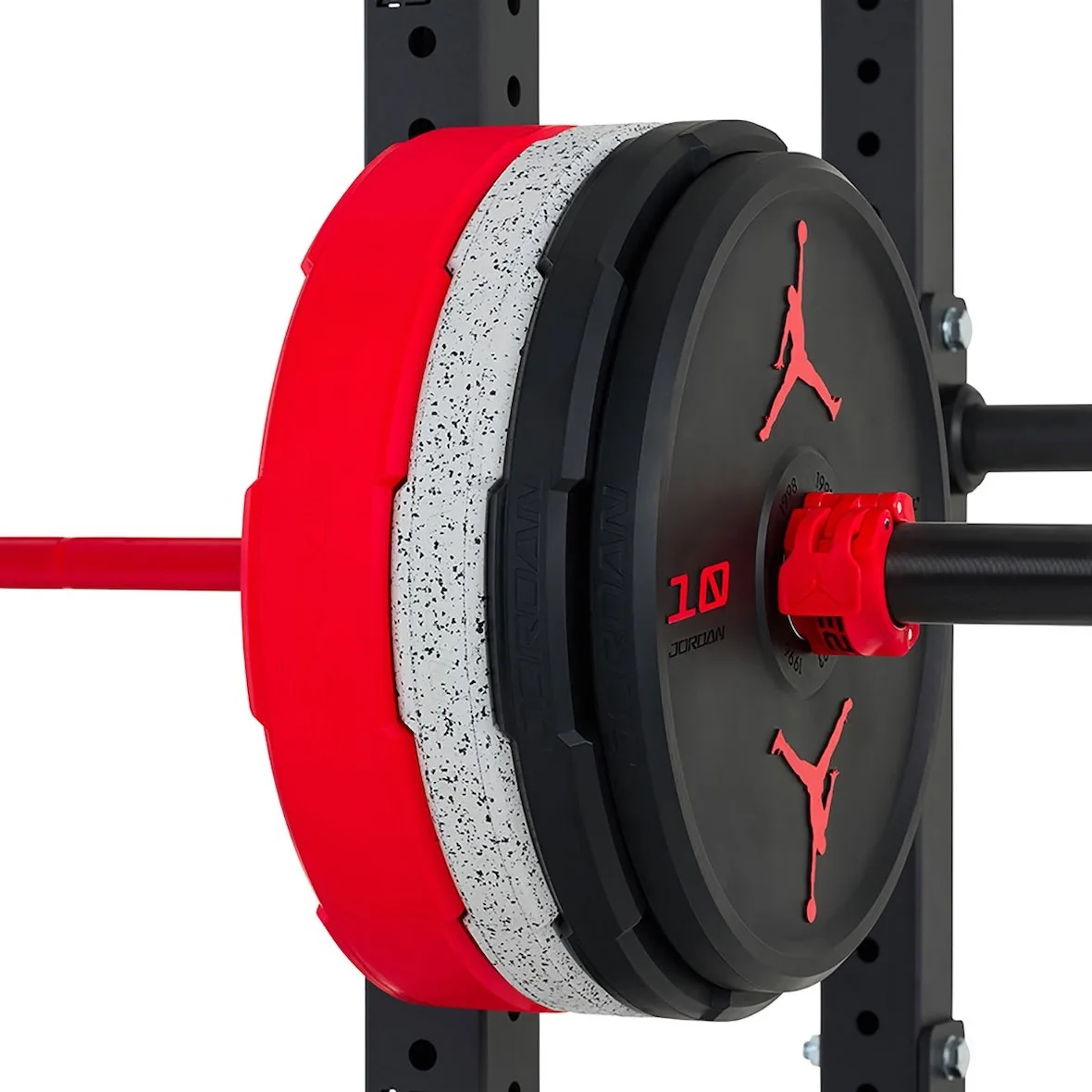close-up of red, speckled and black plates on barbell with 10 marking, Jordan Strength Collection