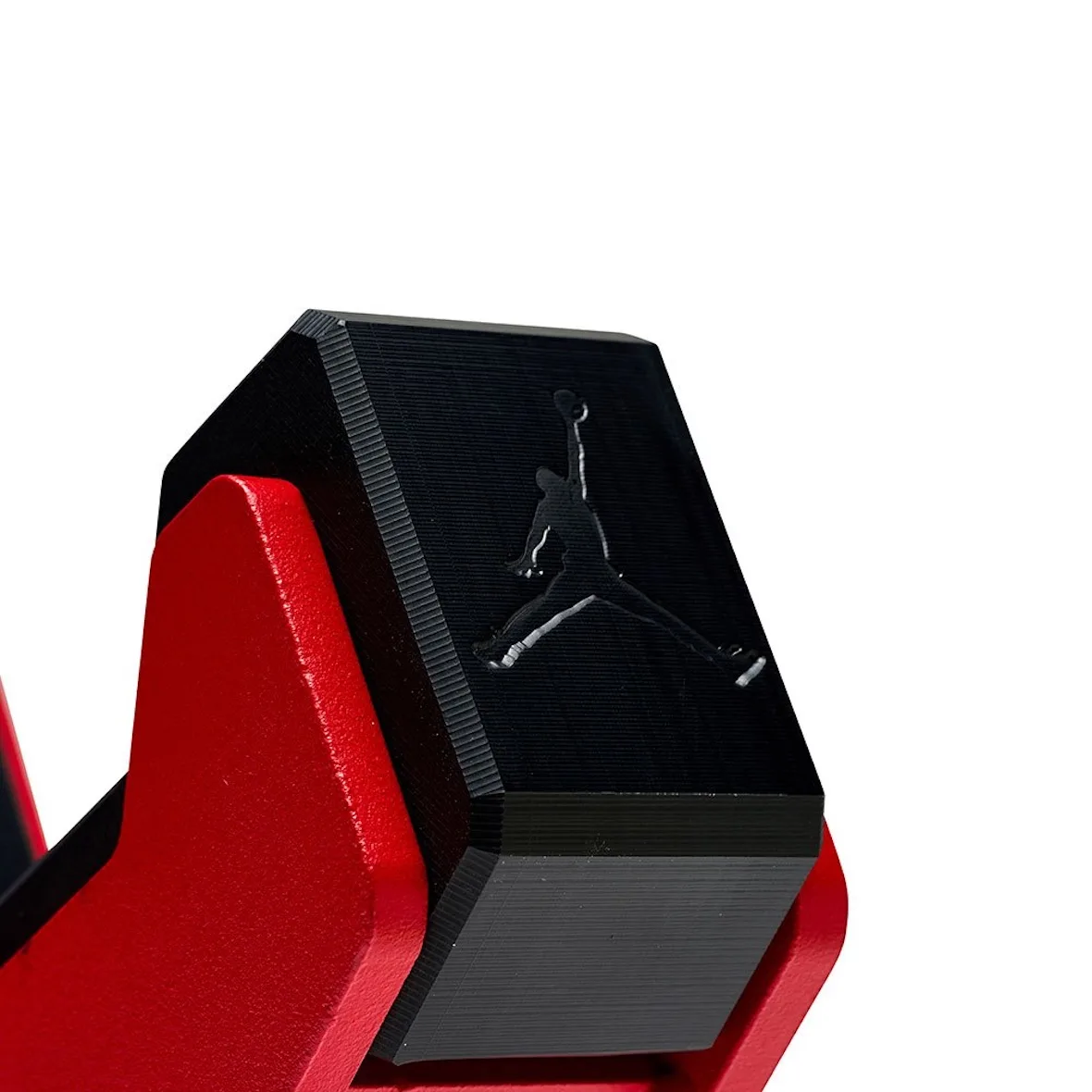 close-up of black hex dumbbell end showing debossed Jumpman logo, Jordan Strength Collection
