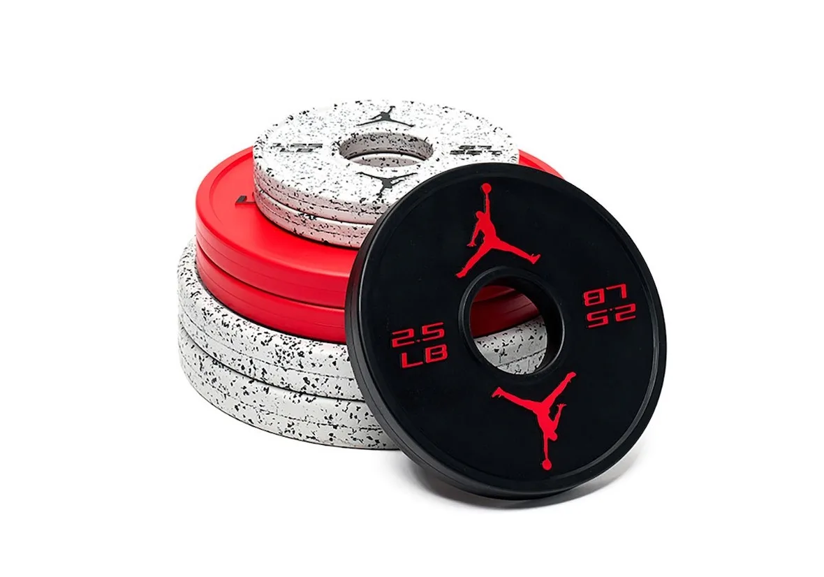 stack of red, speckled grey and black weight plates with Jumpman logos, Jordan Strength Collection