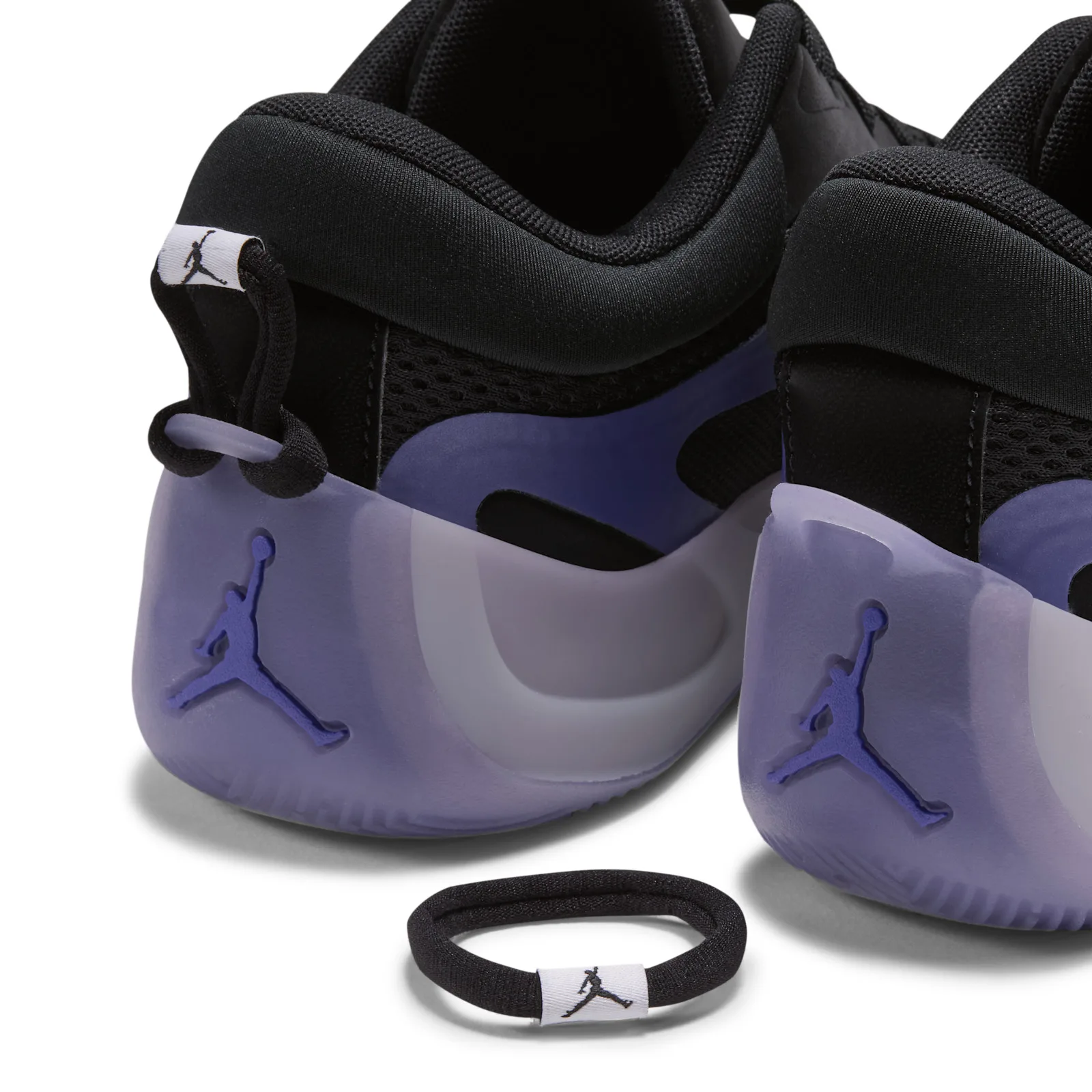 heel detail of pair with purple Jumpman logo, plus a spare lace toggle charm, Concord