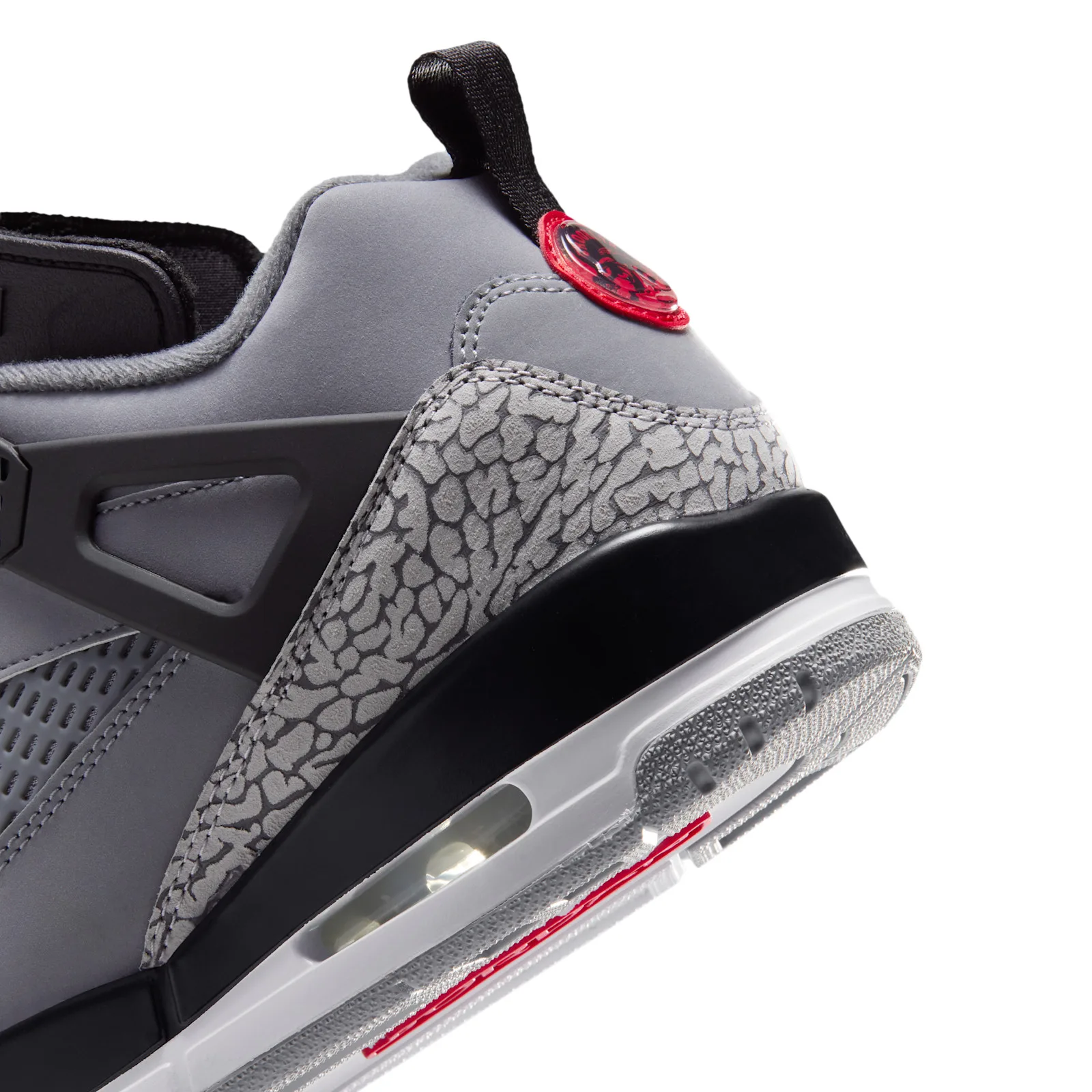 Close-up of heel, red circular pull tab, elephant-print and black midsole, Cool Grey