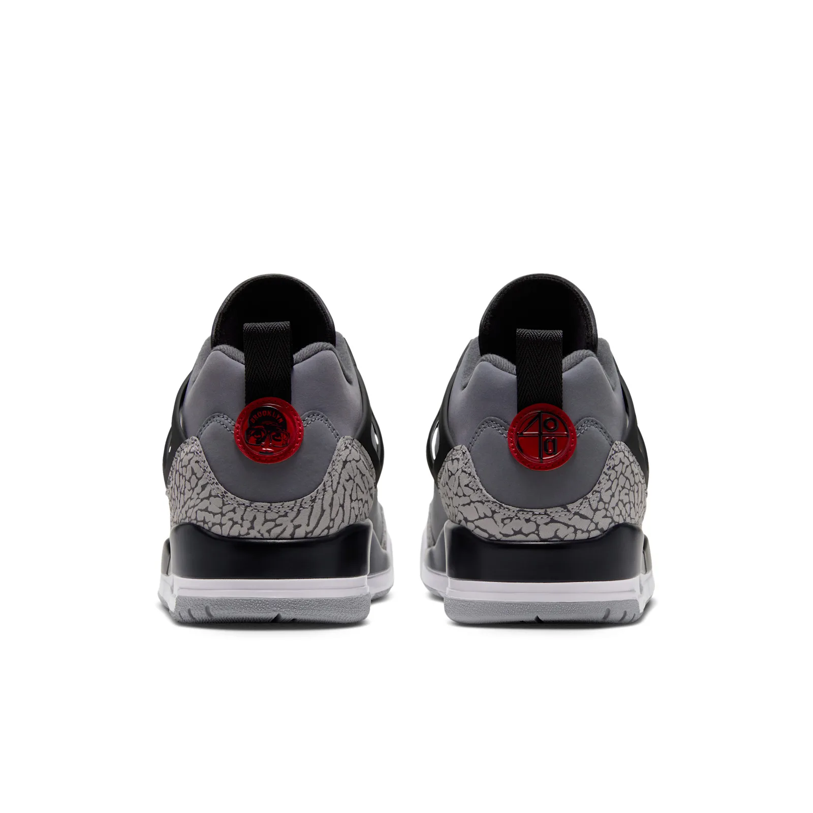 Heel view of pair on white, red Jumpman pull tabs, elephant-print heel counters, Cool Grey