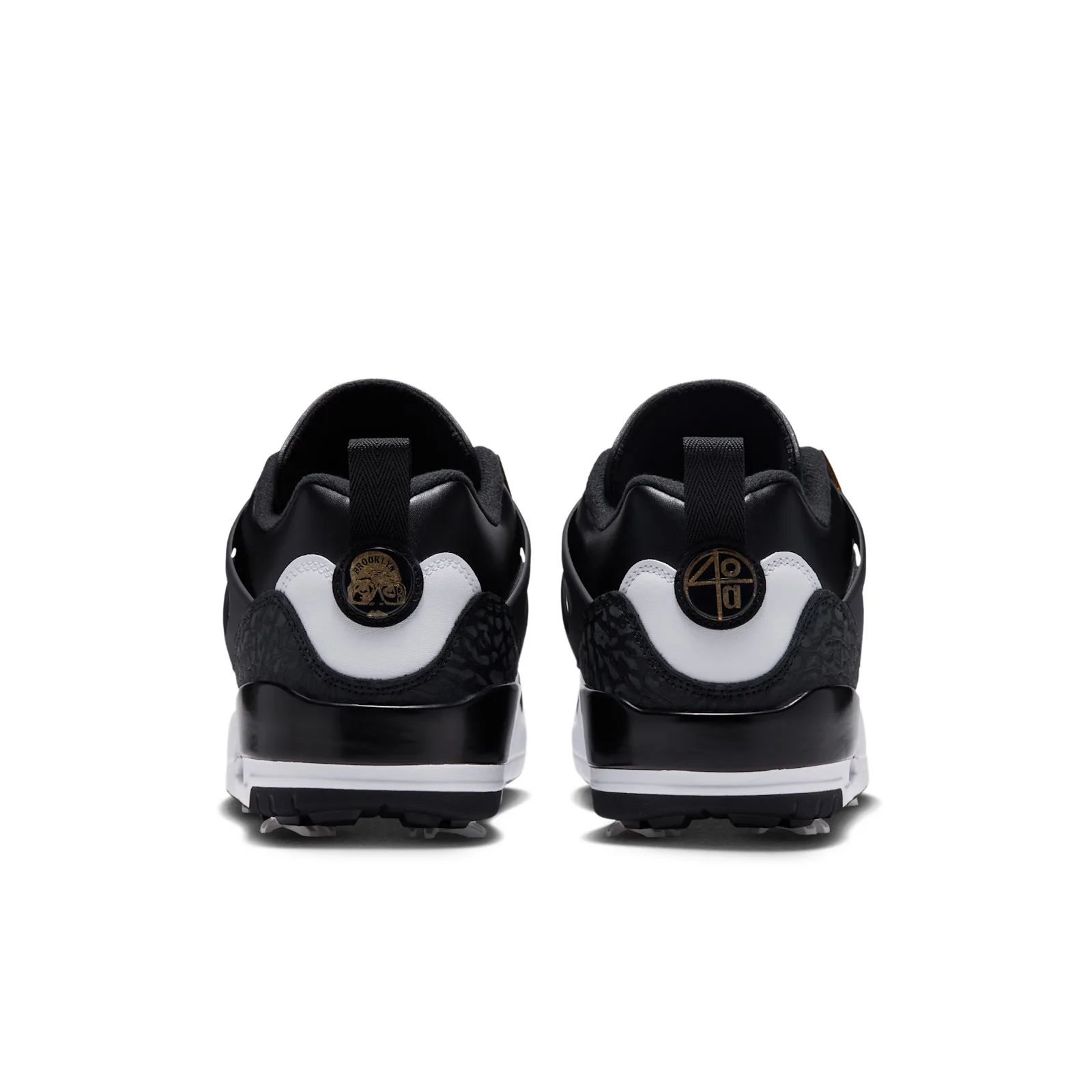 heel view of pair, black and white with gold circular heel medallions, DMP