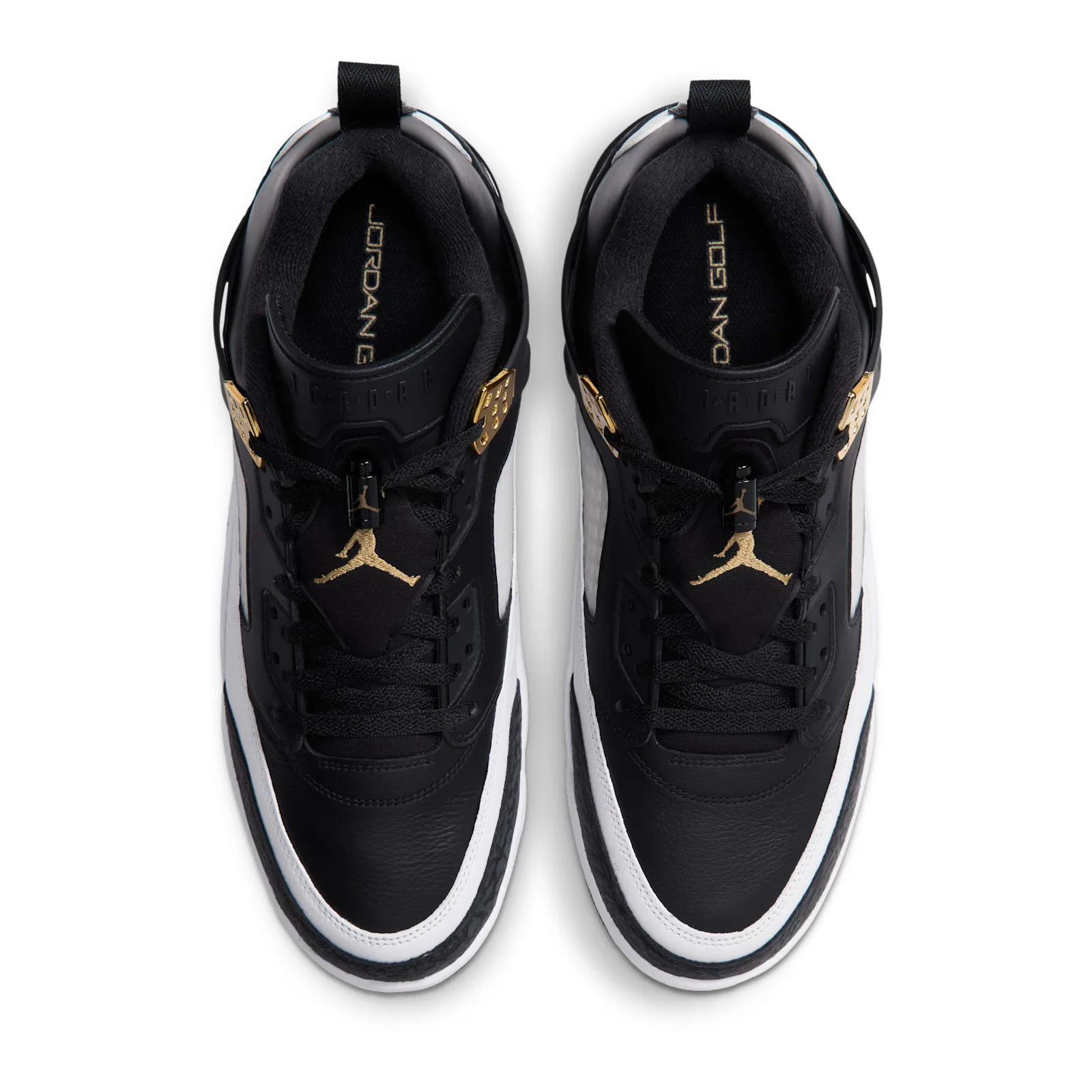 top-down pair view, black and white with gold Jumpman embroidery and gold tongue text, DMP