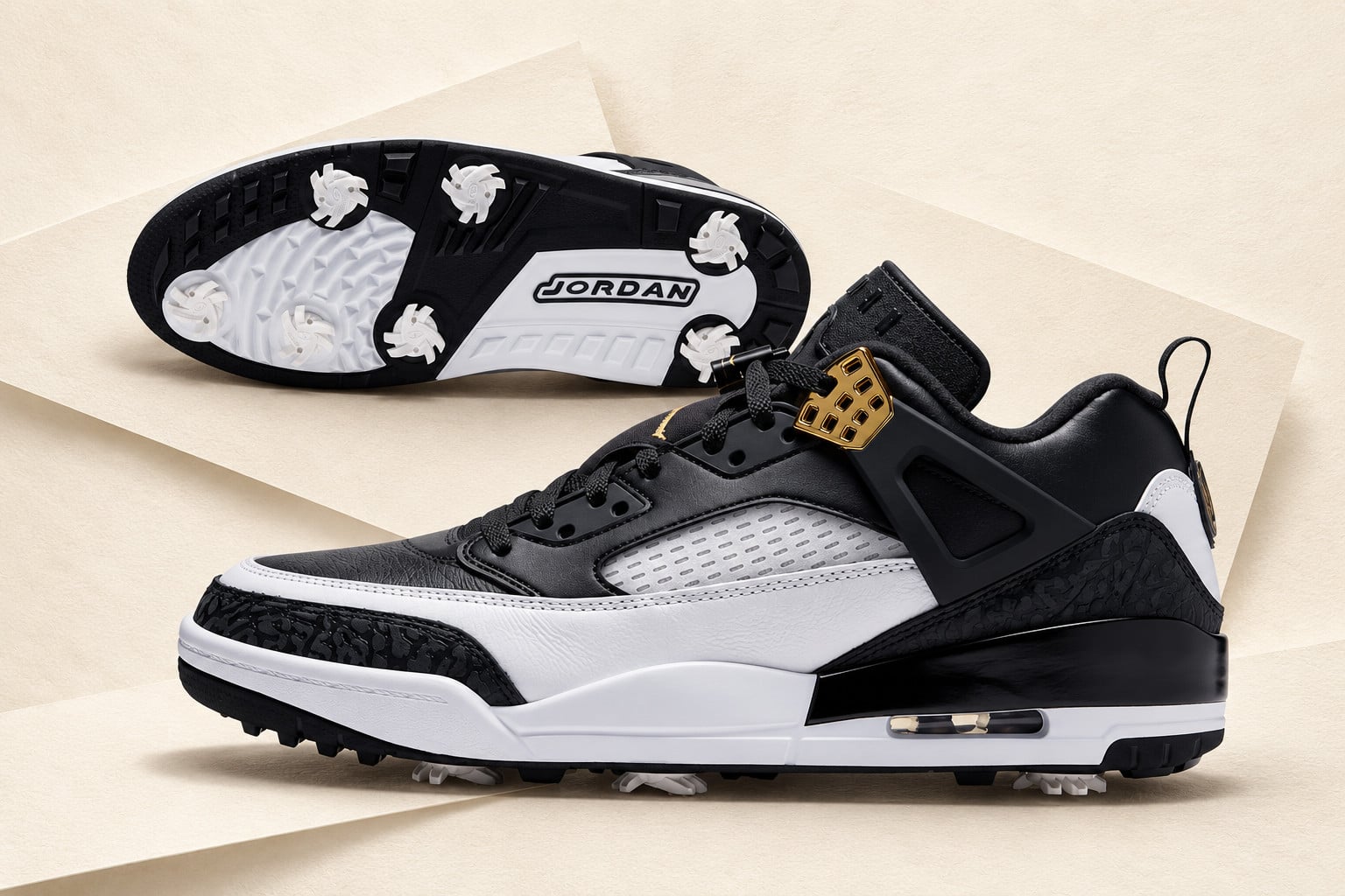 lateral view paired with outsole view on tan background, black, white and gold, Jordan Spizike Low Golf “DMP”