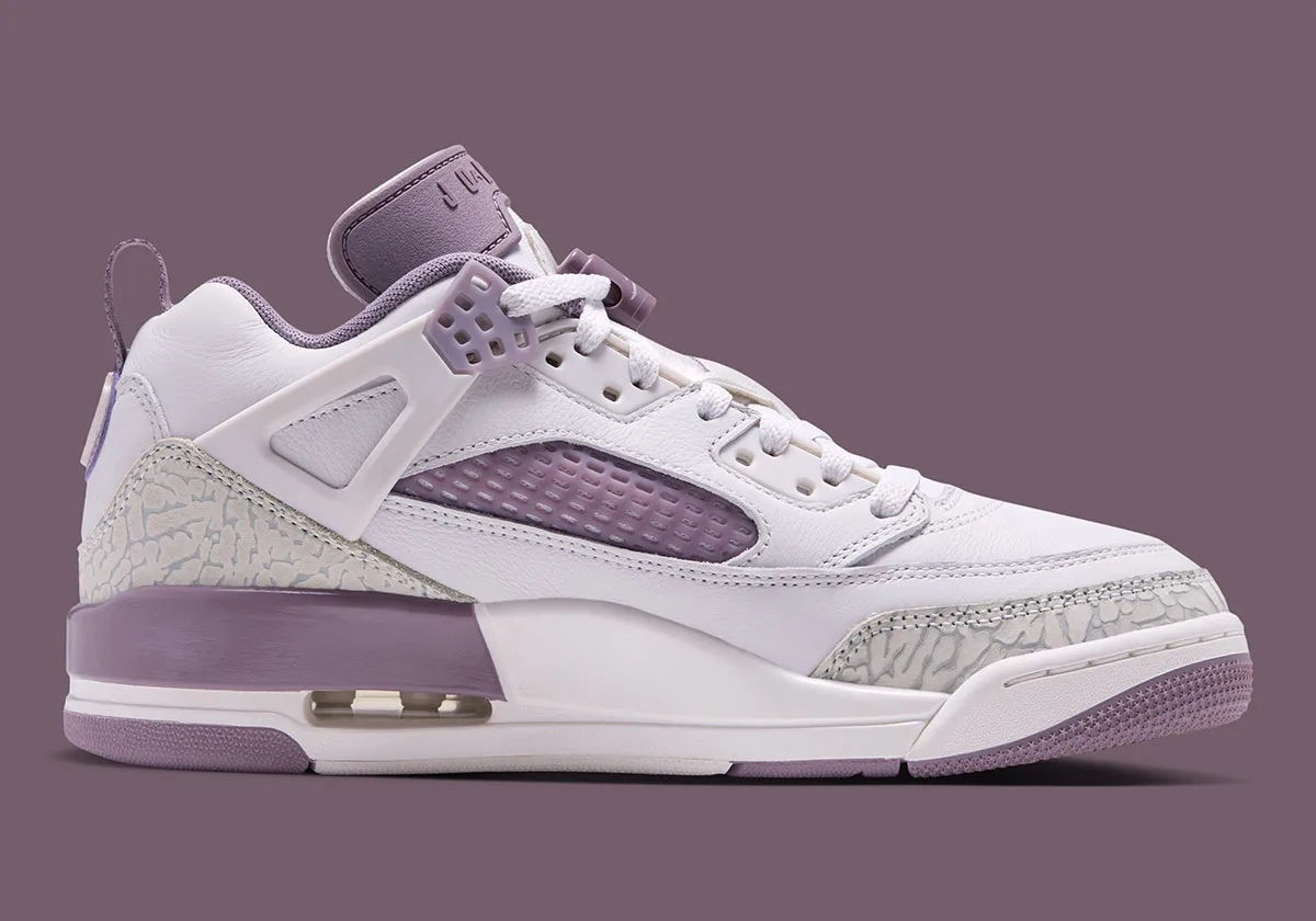 Lateral view on plain background, white and mauve with grey elephant print, Swan