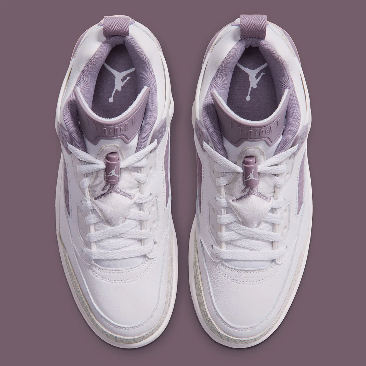 Top-down view of pair showing tongue Jumpman logo and lace loops, Swan