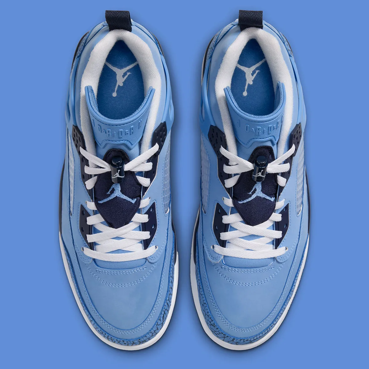 top-down view of pair showing blue tongues with jordan jumpman logo and white laces, UNC